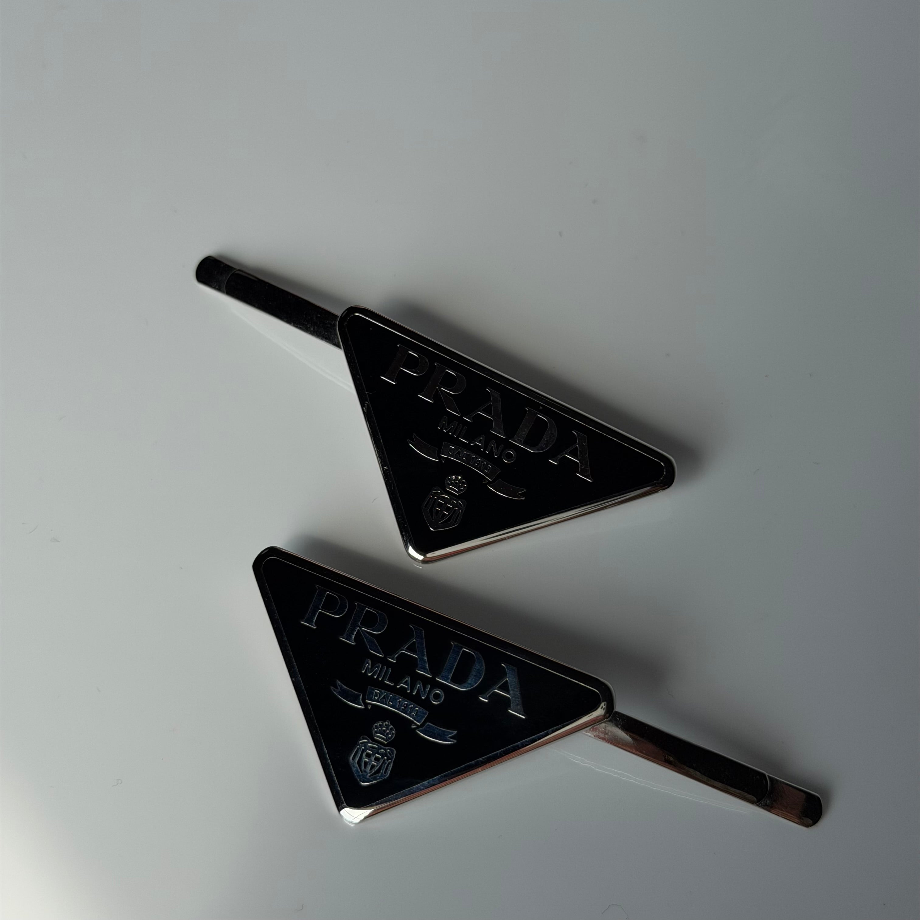 Prada Enamel Triangle Logo Hair Clips