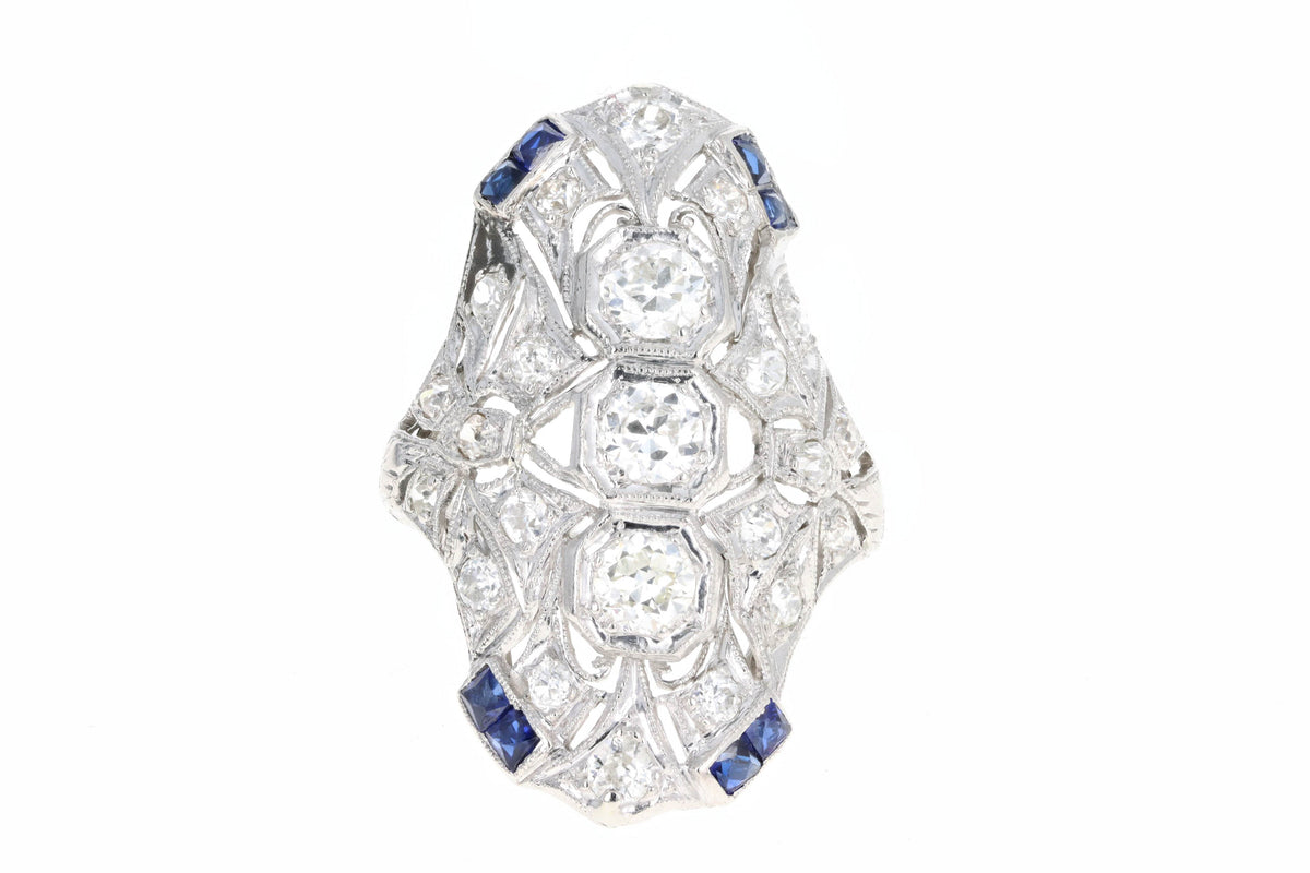 Art Deco Platinum Old European Cut Diamond Three Stone and French Cut Sapphire Hand Engraved Shield Ring - Queen May