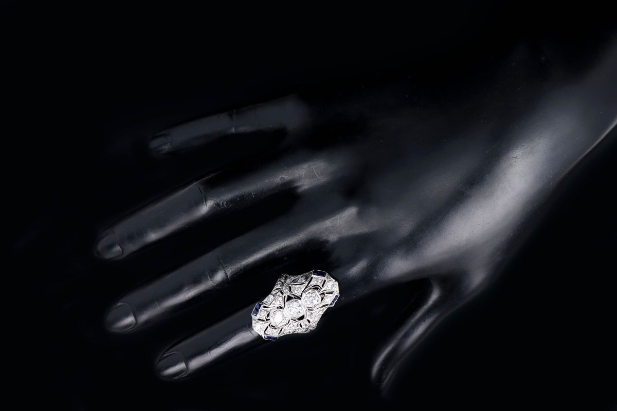 Art Deco Platinum Old European Cut Diamond Three Stone and French Cut Sapphire Hand Engraved Shield Ring - Queen May